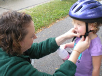 Pediatrics resident Jennifer Jones, MD, adjusts a rider’s helmet.